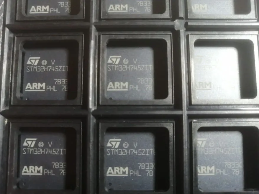 Tray pockets holding black chips marked STM32H745ZIT with ST and ARM logos