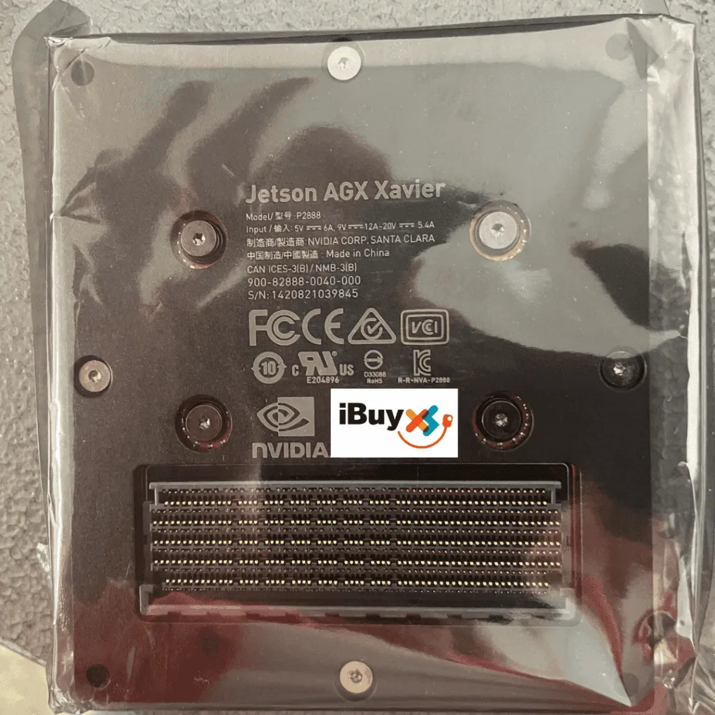 Underside of a Jetson AGX Xavier module in plastic wrap, showing the connector and regulatory marks, with an iBuyXS logo