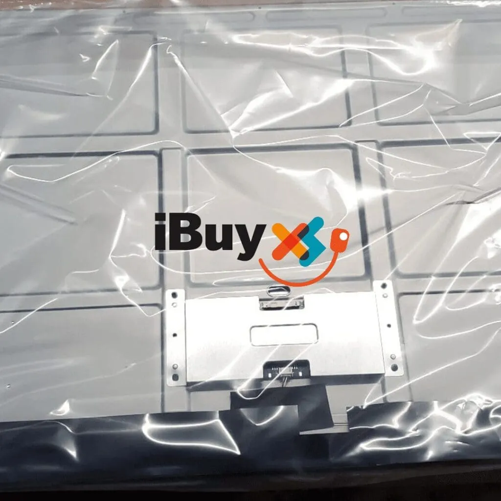 Large flat panel wrapped in clear plastic with a metal bracket and connector at the bottom, overlaid with the iBuyXS logo