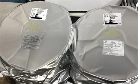 Two reels of components sealed in silver moisture-barrier bags with white labels, sitting side by side