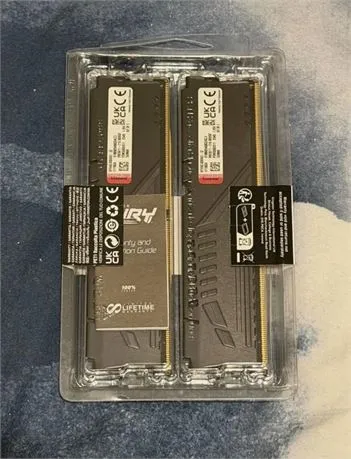 Two black Kingston Fury memory modules sealed in clear blister packaging with warranty guide card